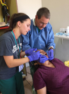 Dr. Rosen helping me give an injection to numb this sweet woman’s mouth before we extracted her tooth. 